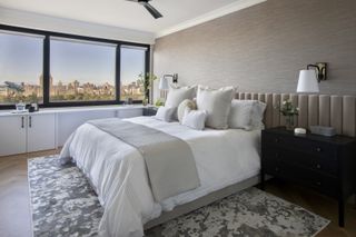 a light brown bedroom with grasscloth wallpaper