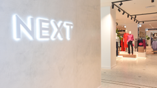A Next logo on the wall of one of its stores