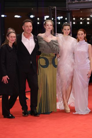 Hunter Schafer poses with a group on the red carpet for the premiere of Cuckoo.