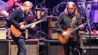 Warren Haynes and Derek Trucks performing onstage with the Allman Brothers Band in 2014