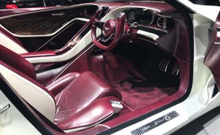 The interior of a purple Bentley EXP12 Speed 6e Concept photographed from the driver's side with the driver's door open