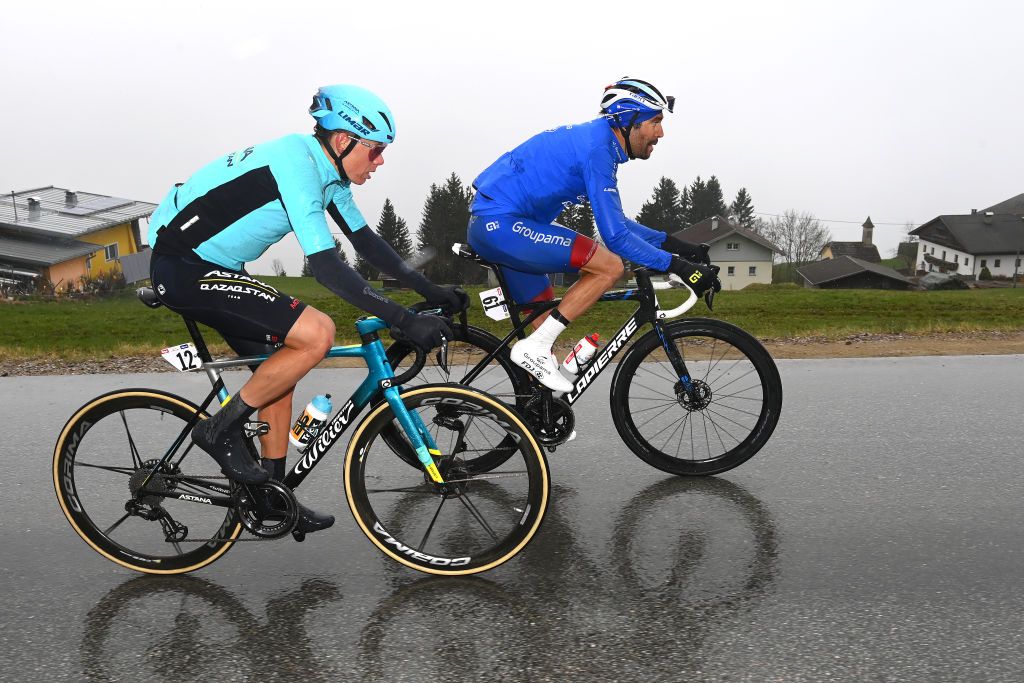 LIENZ AUSTRIA APRIL 22 LR David De La Cruz Melgarejo of Spain and Team Astana Qazaqstan and Thibaut Pinot of France and Team Groupama FDJ compete in the breakaway with rainy and foggy conditions during the 45th Tour of the Alps 2022 Stage 5 a 1145km stage from Lienz to Lienz TouroftheAlps on April 22 2022 in Lienz Austria Photo by Tim de WaeleGetty Images