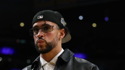 Rapper Rapper Bad Bunny walks courtside during a basketball game
