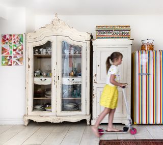 Kitchen with vintage dresser unit and colourful retro fridge