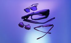 Range of Akoni eyewear suspended in the air, background of merged shades of blue and purple
