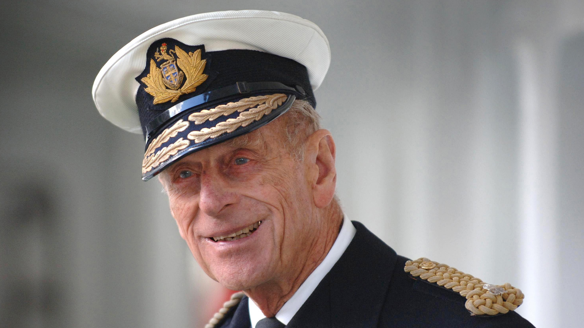 Prince Philip smirks while wearing his military uniform