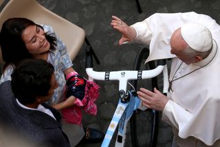 Egan Bernal giving the Pope a bike