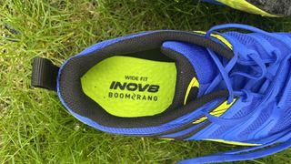 A look inside Inov8 TrailTalon all-terrain running shoes, showing inner sole heel and logo, and wide fit