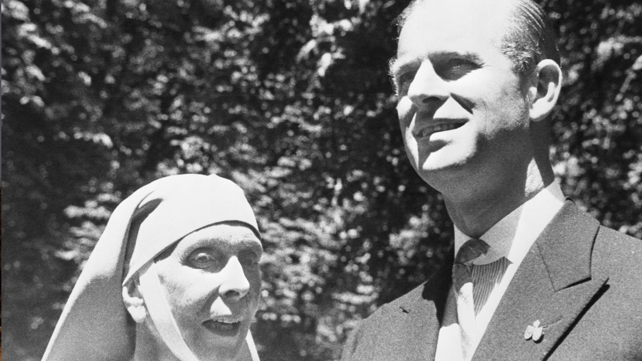 Princess Alice wears a nun&#039;s habit as she poses with her son Prince Philip, who wears a suit on June 10, 1957