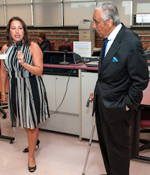 Lisa Nielsen presenting to educators, who are not in the photo. Representative Charlie Rangel is standing next to her.