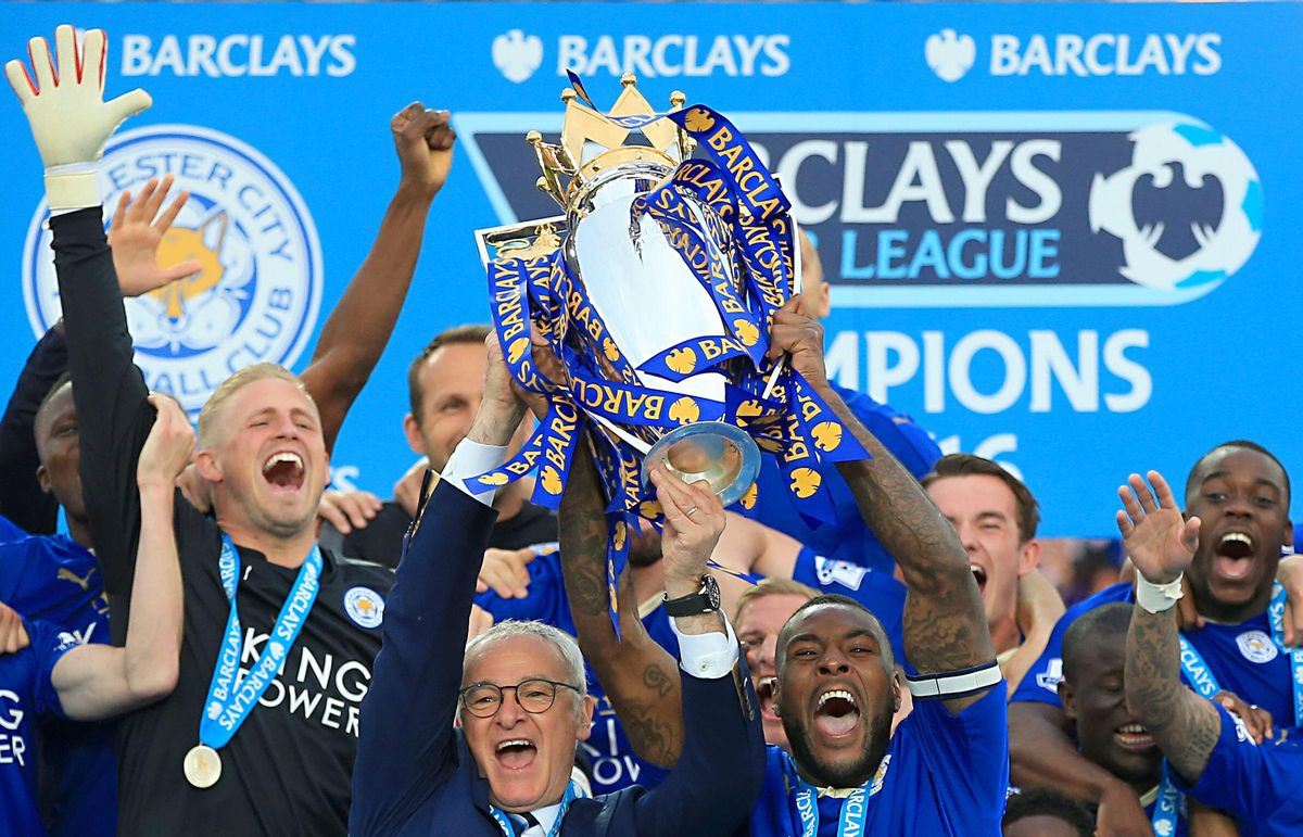 Leicester City manager Claudio Ranieri and captain Wes Morgan lift the Premier League trophy, May 2016