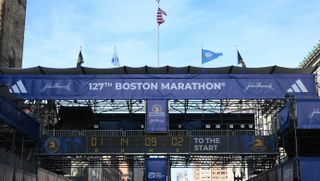 A countdown to the start of the 2023 Boston Marathon is displayed above the Boston Marathon finish line gantry