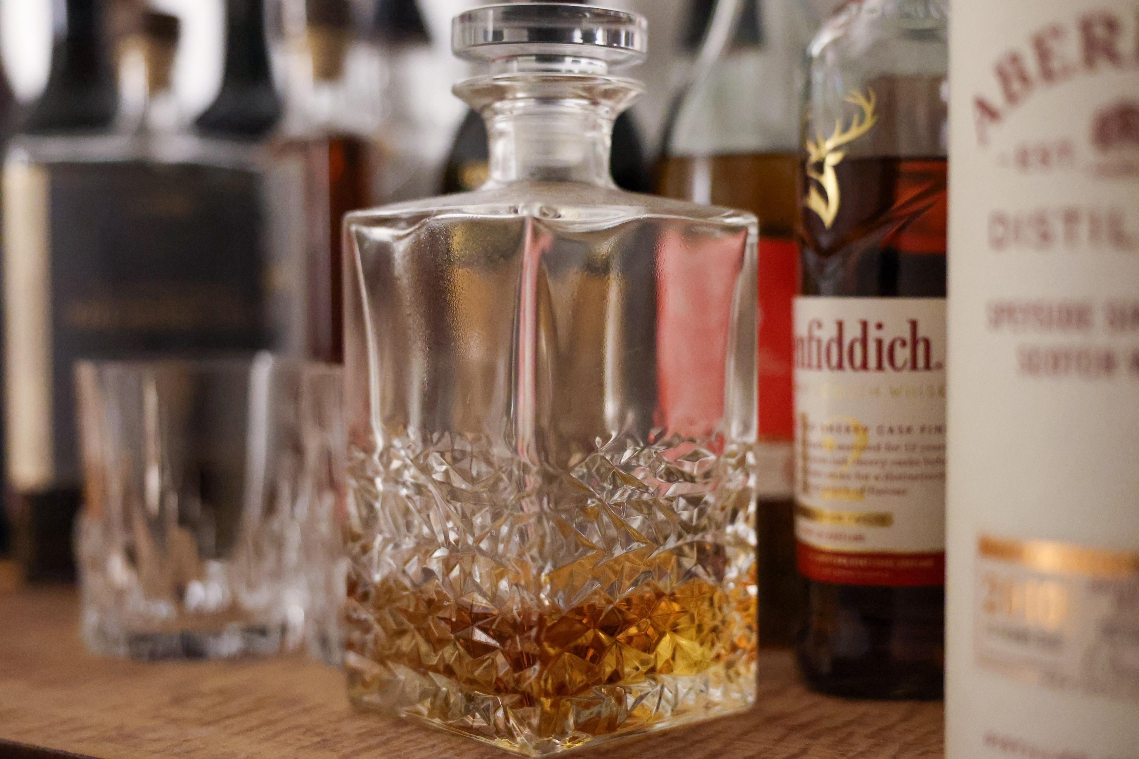 A whisky decanter on a bar top shot at ISO 12,800