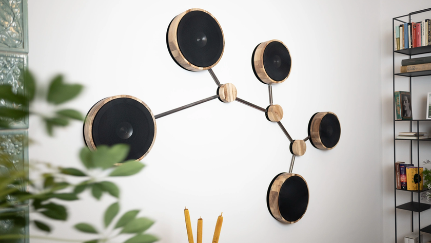 Ultrasonic Molecular Audio system on a white wall, showing multiple wall-mounted speakers connected to look like molecular structures
