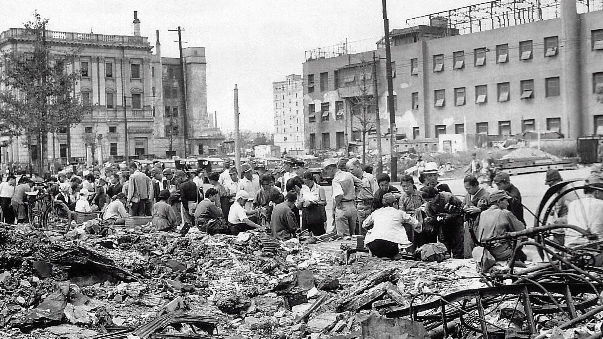 Civilians gather in a ruined area of Tokyo after the March 9 bombing