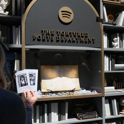 Attendees take pictures at Spotify's Taylor Swift pop-up at The Grove for her new album "The Tortured Poets Department" at The Grove on April 16, 2024 in Los Angeles, California. 