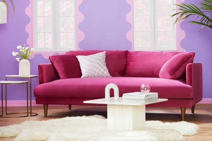 a pink sofa in a lilac living room