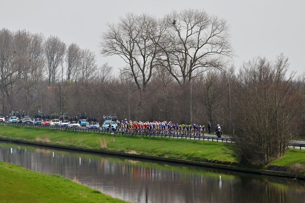 DE PANNE BELGIUM MARCH 20 A general view of the peloton passing through a landscape during the 48th Classic BruggeDe Panne 2024 Mens Elite a 1989km one day race from Brugge to De Panne UCIWT on March 20 2024 in De Panne Belgium Photo by Luc ClaessenGetty Images