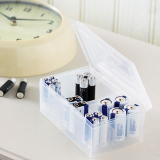 plastic storage box with battery and watch