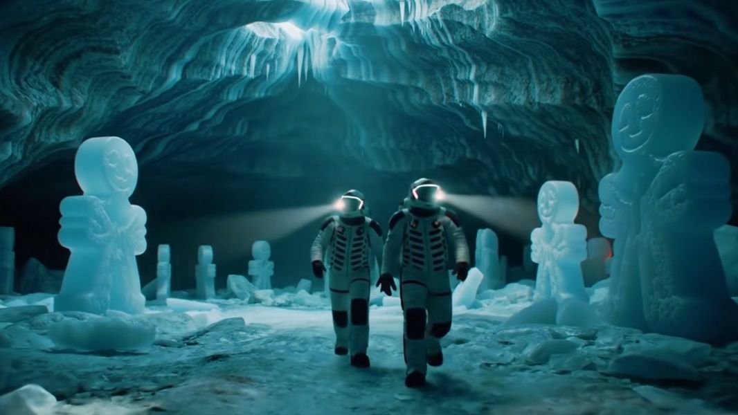 Gemini Advanced users can utilize Veo 2's integration to create detailed, high-quality videos from text descriptions, like of two astronauts walking through an icy cavern.