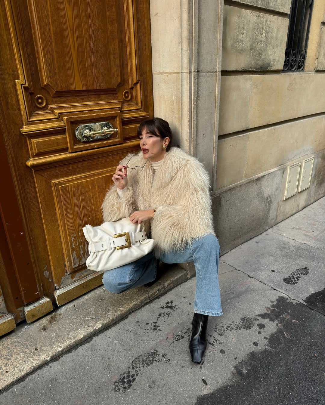@juliesfi wearing a faux fur jacket and jeans