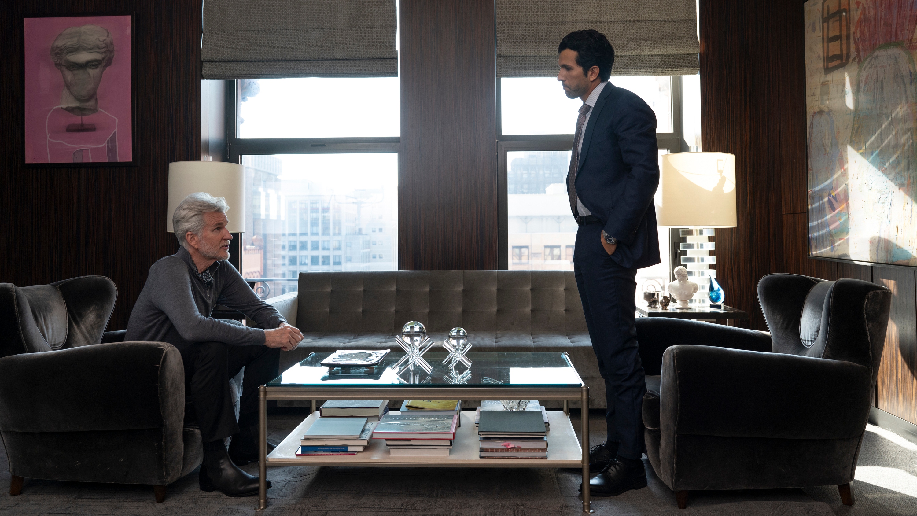 Jake and Bill standing in a plush office having what looks like a deep conversation. 