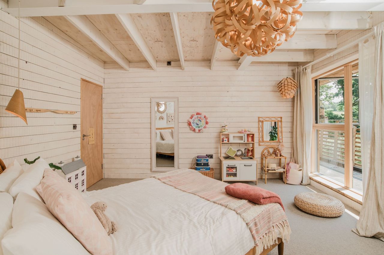 The bedroom has wooden walls and roofing