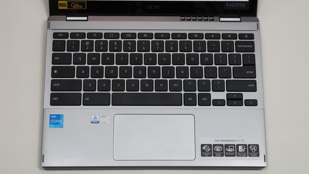 A top-down view of the keyboard and trackpad area of a laptop