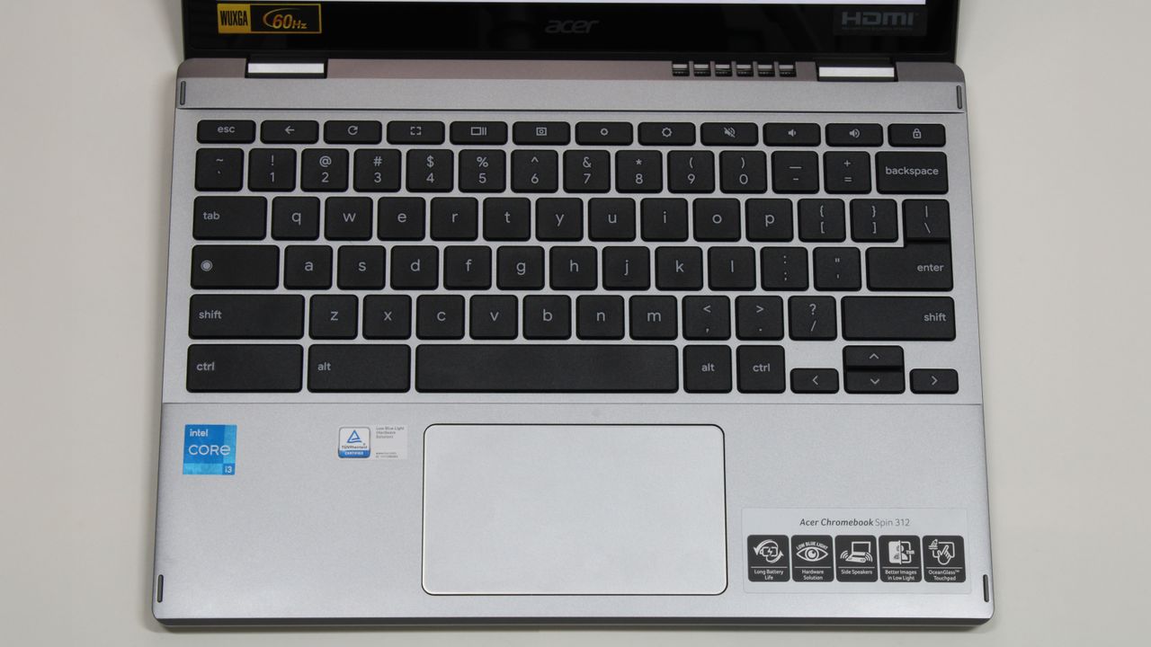 A top-down view of the keyboard and trackpad area of a laptop