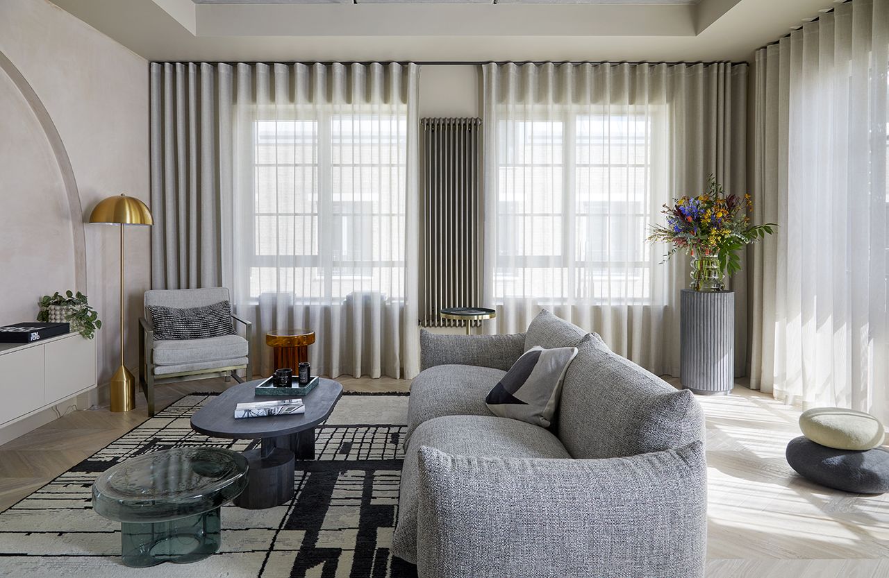 modern living room with grey sofa and pale wood floors