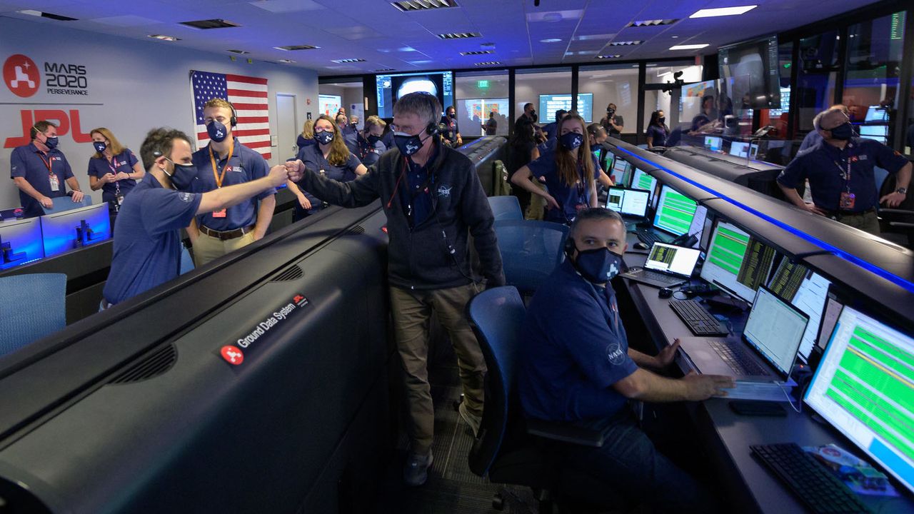 Members of NASA&rsquo;s Perseverance rover team react in mission control after receiving confirmation the spacecraft successfully touched down on Mars, Thursday, Feb. 18, 2021, at NASA's Jet Propulsion Laboratory in Pasadena, California.