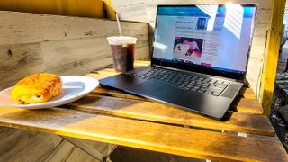 Razer Blade 15 on a table next to coffee and a croissant
