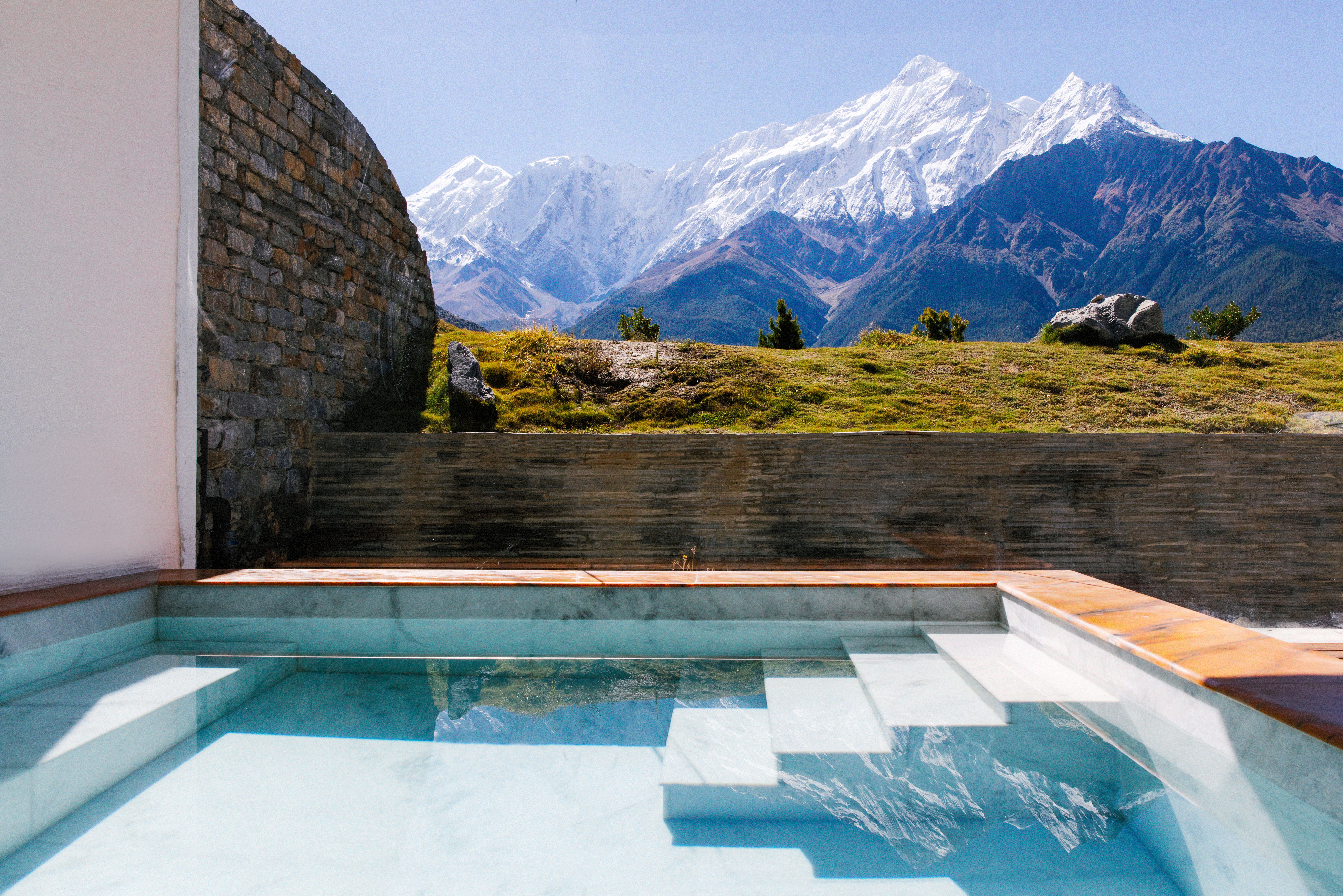outdoor pool with snow-topped mountains behind