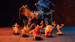 Bardsung miniatures face off against one another on a wooden table