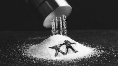 Photo collage of children making snow angels in a giant pile of salt, pouring out of a salt shaker above them