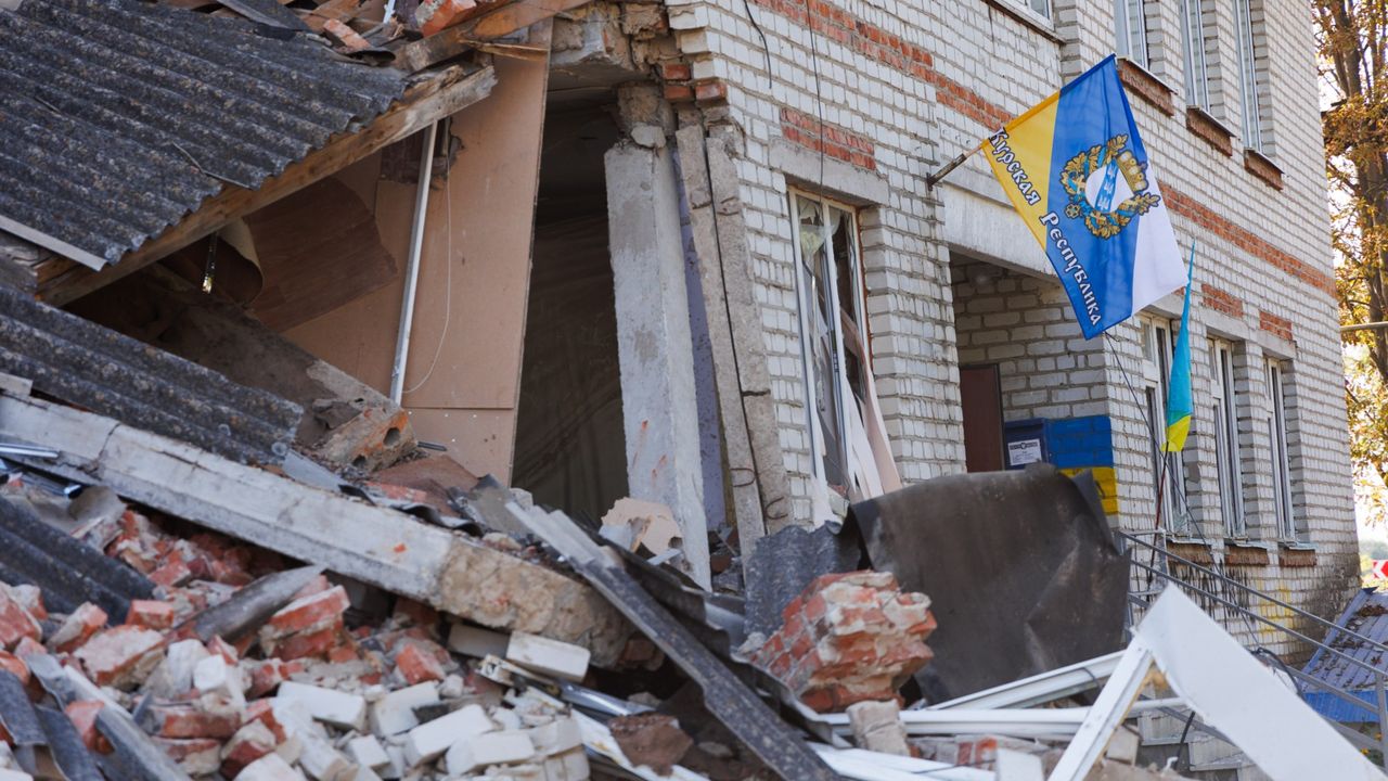 A flag of the Kursk region is placed on a damaged building in Sudzha, Russia.