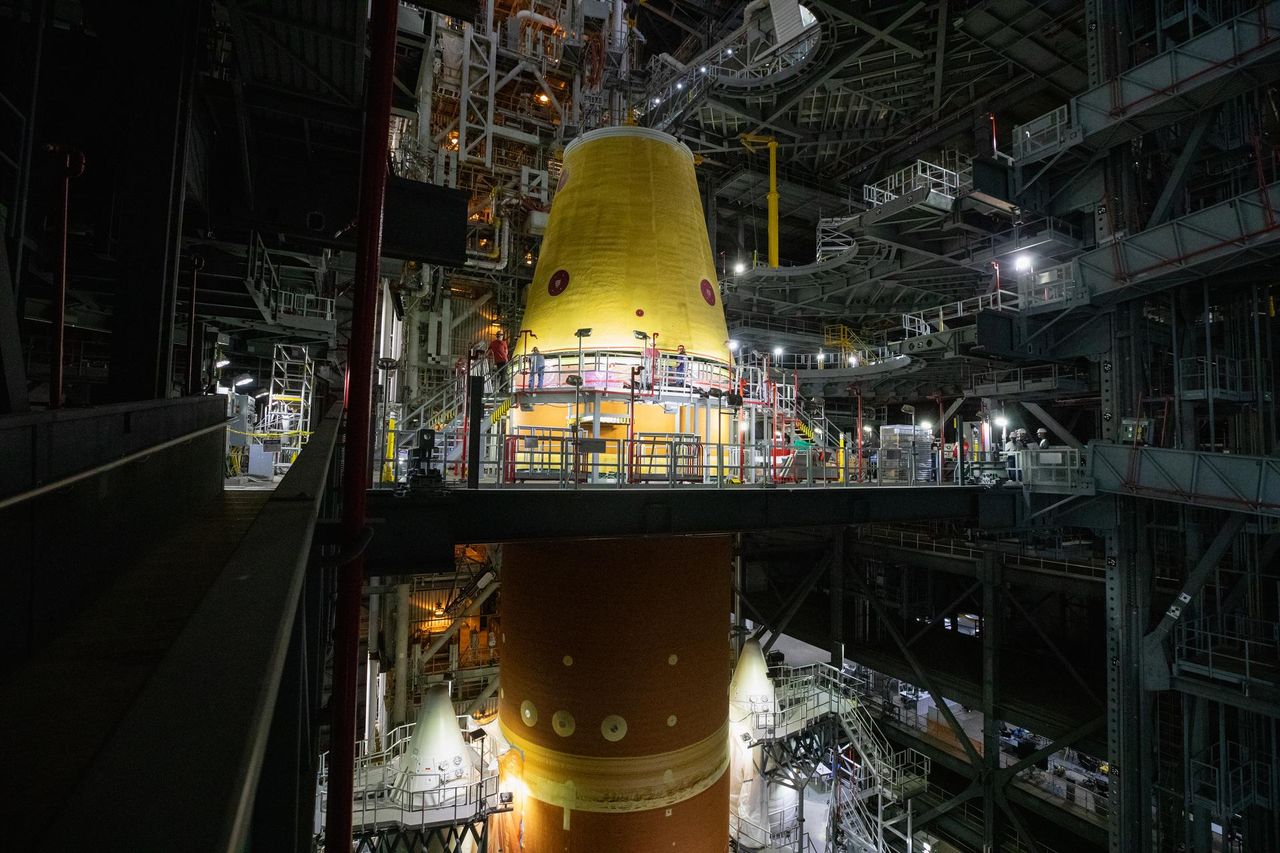 A massive crane lowers the launch vehicle stage adapter onto the SLS (Space Launch System) core stage on Thursday, April 3, 2025, in High Bay 3 inside the Vehicle Assembly Building at NASA&rsquo;s Kennedy Space Center in Florida.