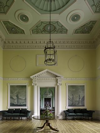 Crichel, Dorset: The East Hall stands between the Dining Room and Drawing Room. Its Classical landscapes in grisaille, which were probably covered over in the 1830s, and the ceiling have been revealed again during the recent restoration work