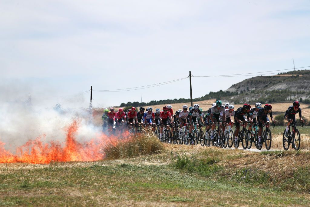 BURGOS SPAIN AUGUST 03 Marcus Burghardt of Germany and Team Bora Hansgrohe Damien Touz of France and AG2R Citren Team Egan Arley Bernal Gomez of Colombia Daniel Felipe Martinez Poveda of Colombia Carlos Rodriguez Cano of Spain and Team INEOS Grenadiers The Peloton passing close to a fire during the 43rd Vuelta a Burgos 2021 Stage 1 a 161km stage from BurgosCatedral to BurgosAlto del Castillo 980m VueltaBurgos BurgosCycling CapitalMundialdelCiclismo catedral2021 on August 03 2021 in Burgos Spain Photo by Gonzalo Arroyo MorenoGetty Images