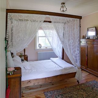 guest bedroom with rug on floor and bed with pillows
