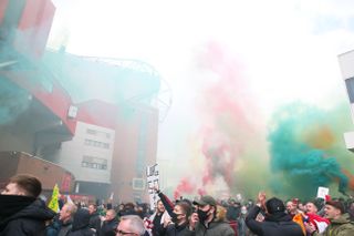 Manchester United fans make their way into Old Trafford as they protest against the Glazer family
