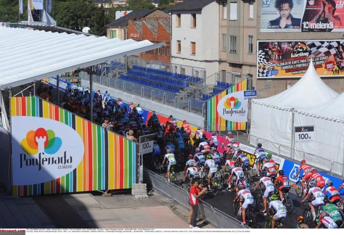 The peloton enters the finish/start line to begin another lap