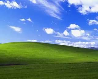 Microsoft Windows XP default wallpaper showing rolling green hills of Sonoma County, California with a brilliant blue sky.