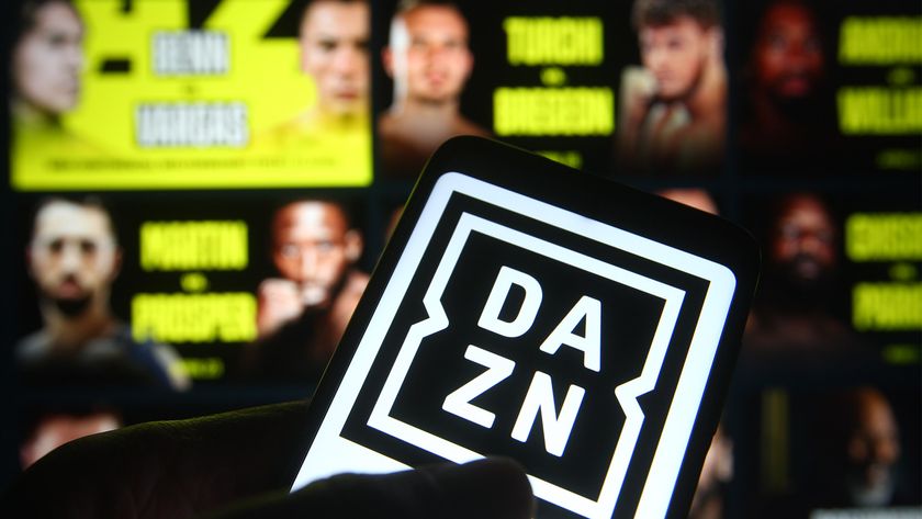 A phone held in front of a screen that shows boxing fights on a sports streaming services with the DAZN logo 