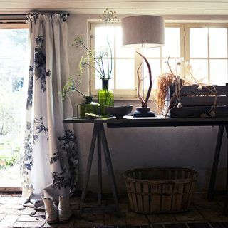 monochrome utility room with floral door curtain