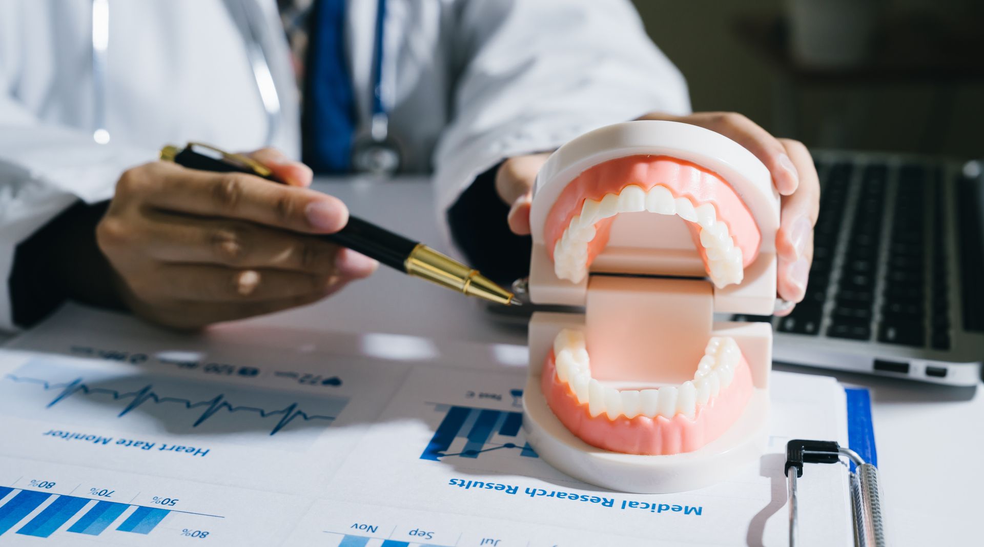 Doctor pointing to a model of teeth with a pen
