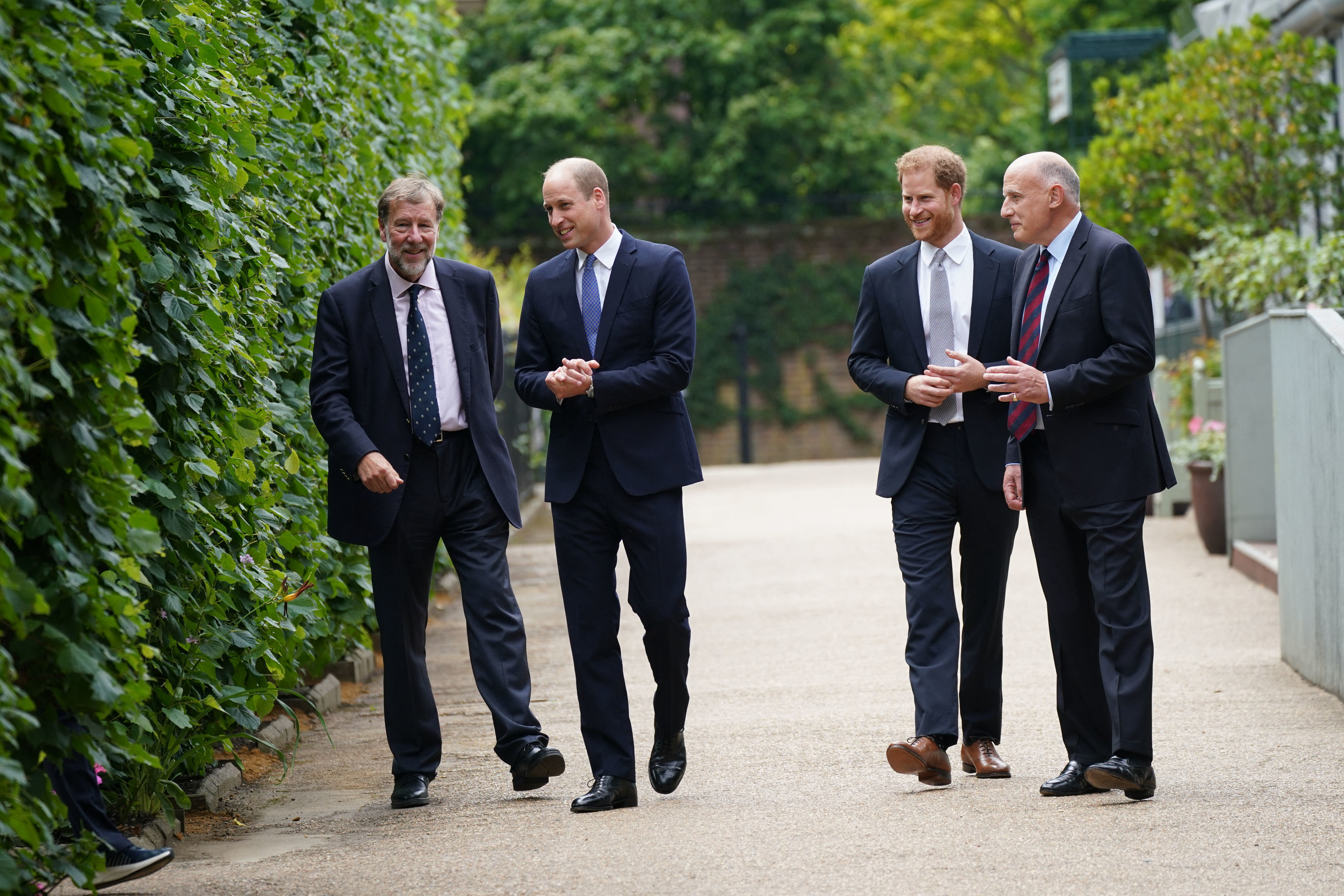 Prince William and Prince Harry standing with Jamie Lowther-Pinkerton and Rupert Gavin