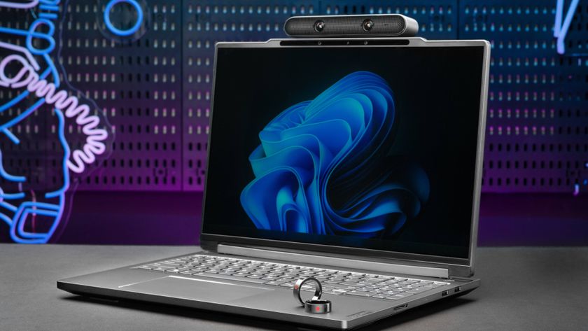 Lenovo ThinkBook 3D laptop Concept with AI Ring on table with neon sign backgrounds