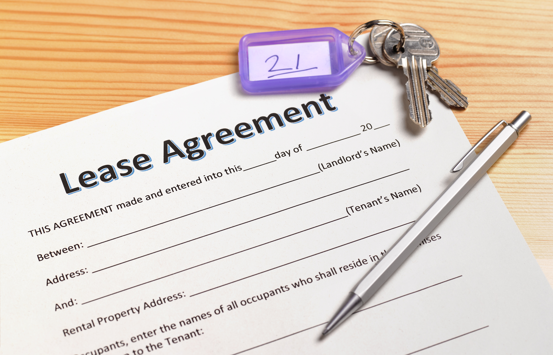 A lease agreement waiting to be signed with house keys.