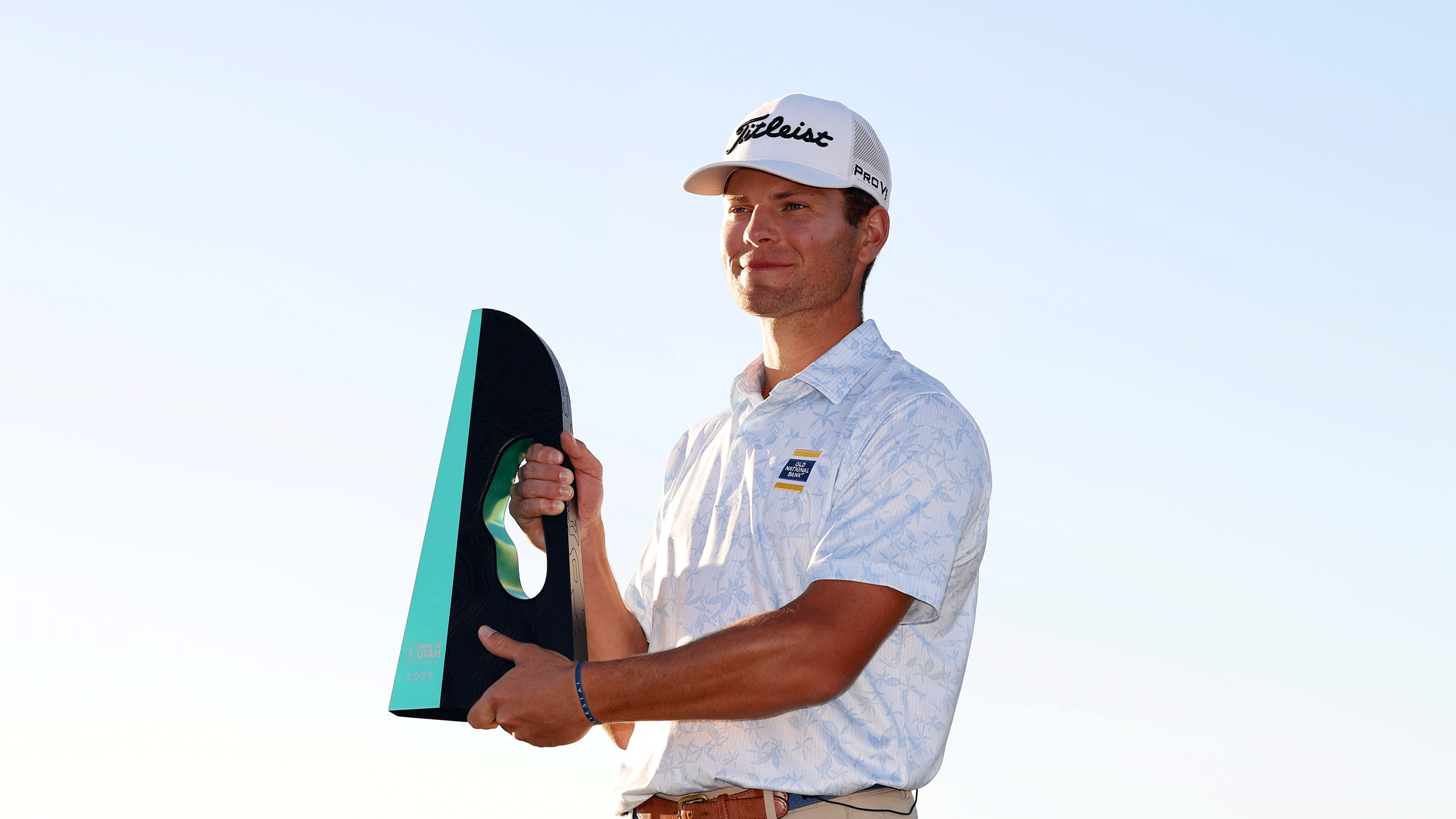 Michael Brennan poses with the Bank of Utah Championship following his win in 2025